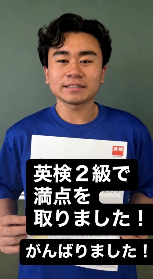 用紙を掲げて記念撮影する生徒